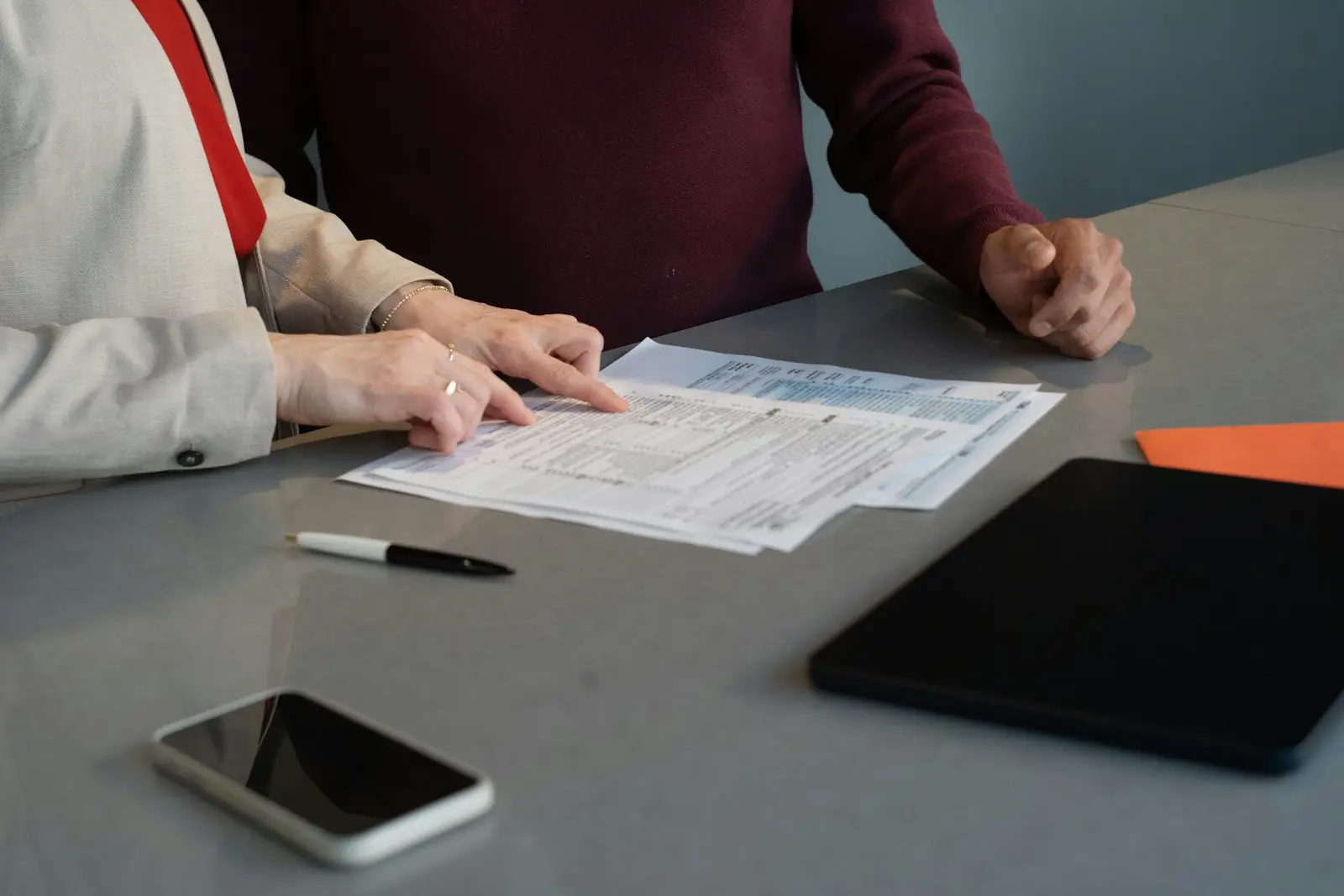 Two people reviewing application forms together at a table